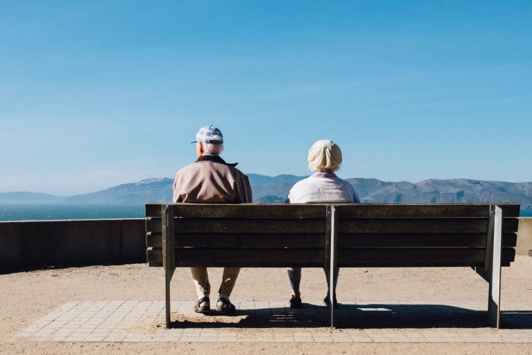 elderly people sitting on bench