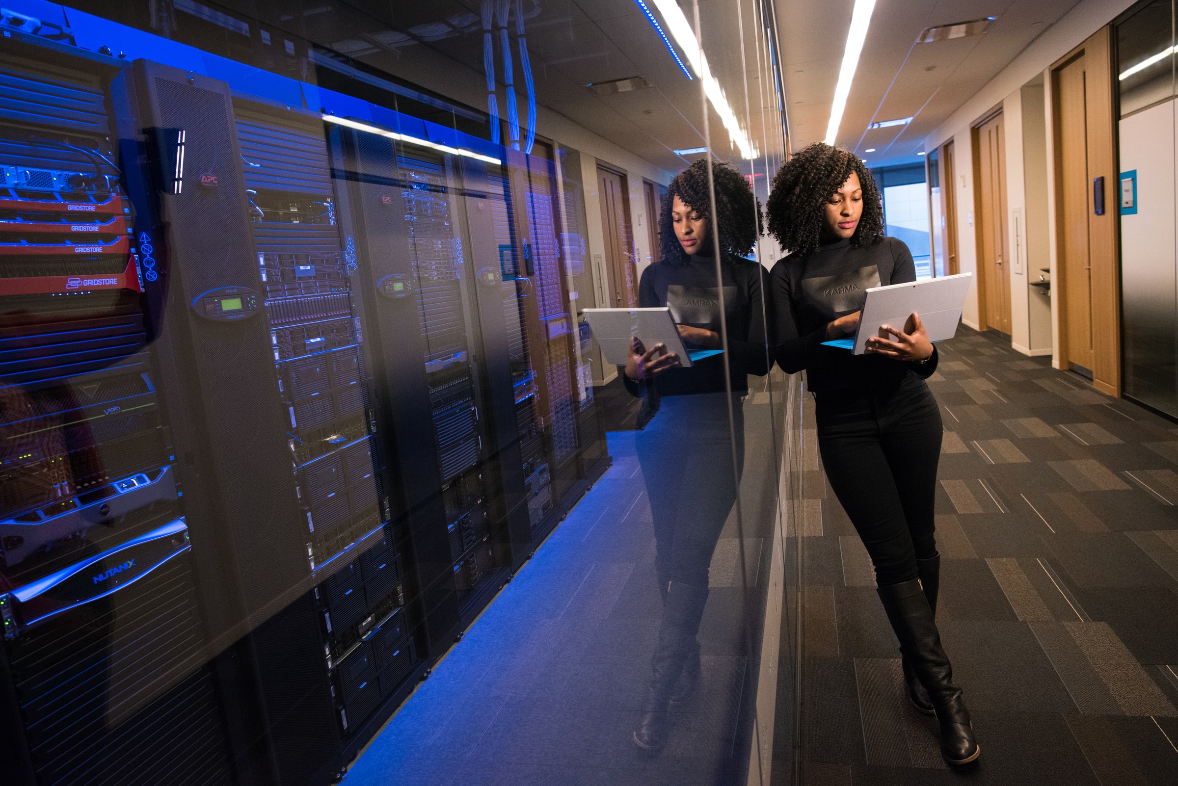 black woman leaning next to web servers