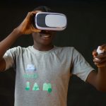 black man playing with the metaverse with controller