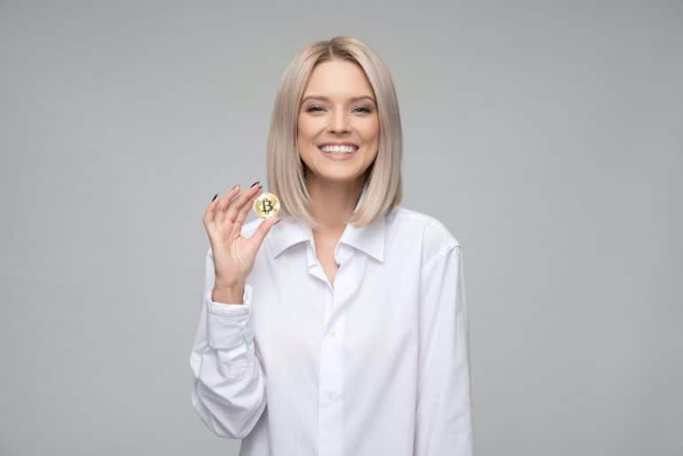 woman holding bitcoin coin