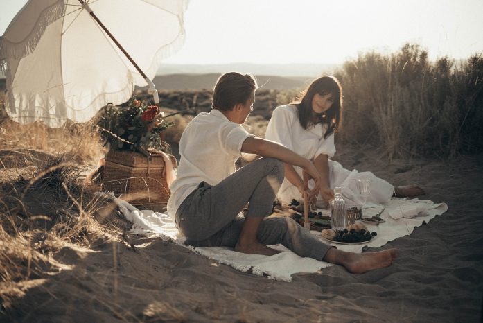 young couple having a picnic at the park