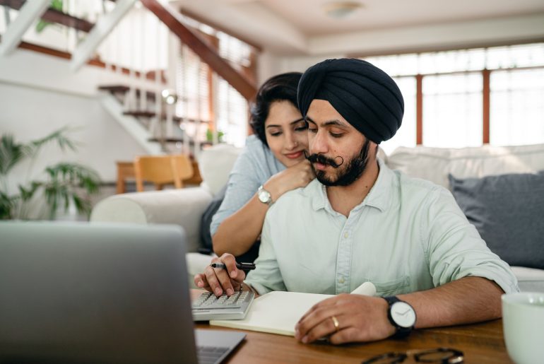 young indian couple doing finances together