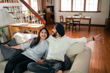 happy couple sharing living space with inlaws at home