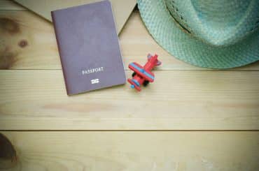 passport book near a airplane toy