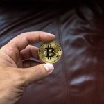 person holding a bitcoin