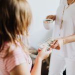 mother giving daughter money