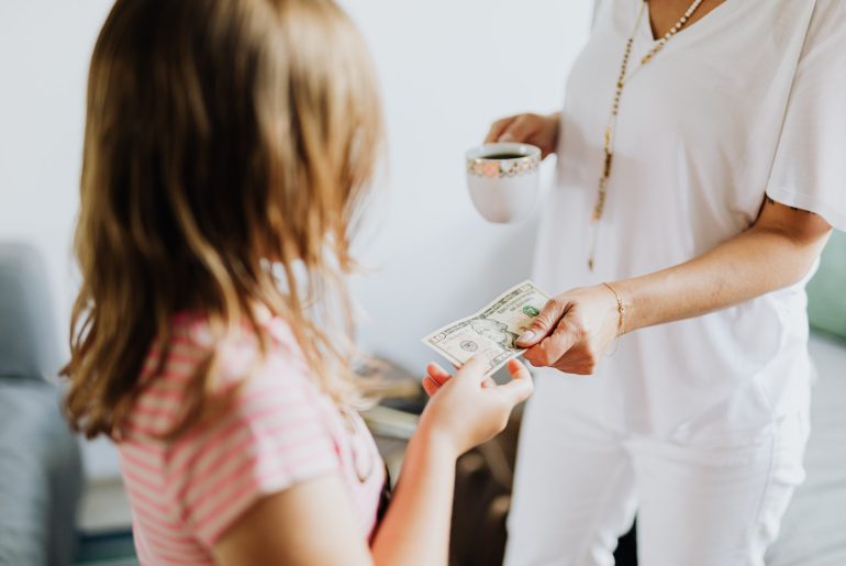 mother giving daughter money