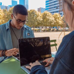 man and women sitting working on laptop