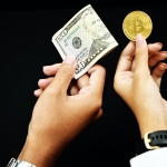 hand holding money and bitcoin