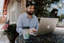 a bearded man working on a laptop