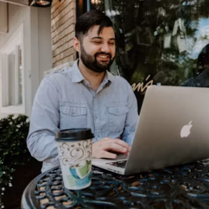a bearded man working on a laptop